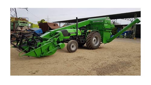Heavy-duty tractor front view with green paint and large tires
